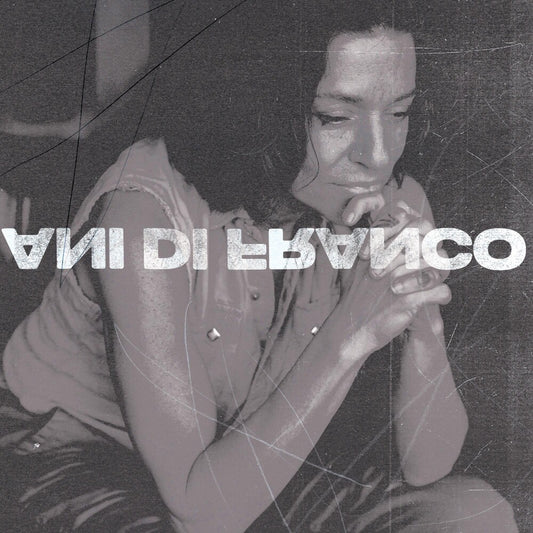 the album cover for ANI DIFRANCO	 - UNPRECEDENTED SH!T [INDIE EXCLUSIVE COKE BOTTLE CLEAR LP]	